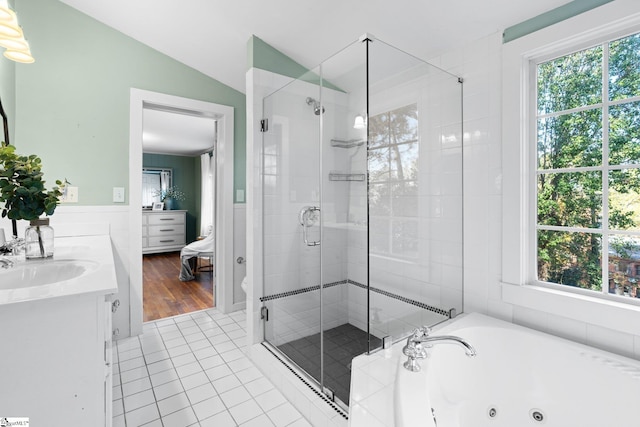 bathroom featuring hardwood / wood-style floors, plenty of natural light, vanity, and vaulted ceiling