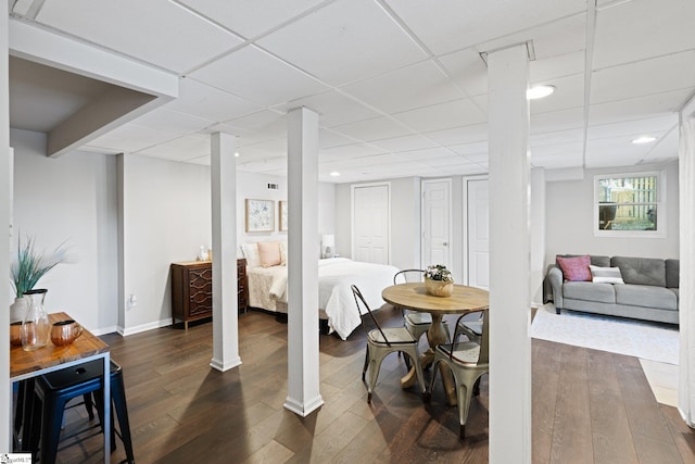 interior space with dark hardwood / wood-style flooring and a paneled ceiling