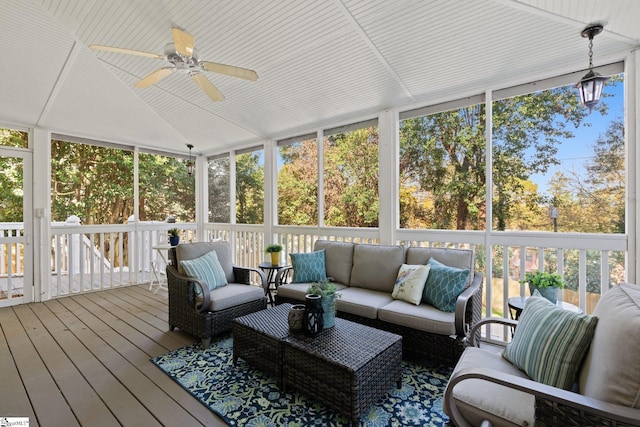 sunroom with ceiling fan and vaulted ceiling