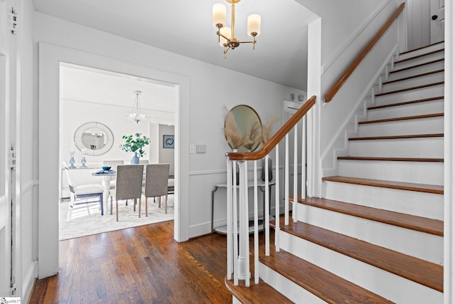 entryway featuring dark hardwood / wood-style flooring and a notable chandelier