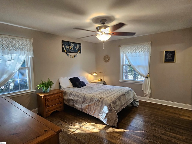 bedroom featuring ceiling fan and dark hardwood / wood-style flooring