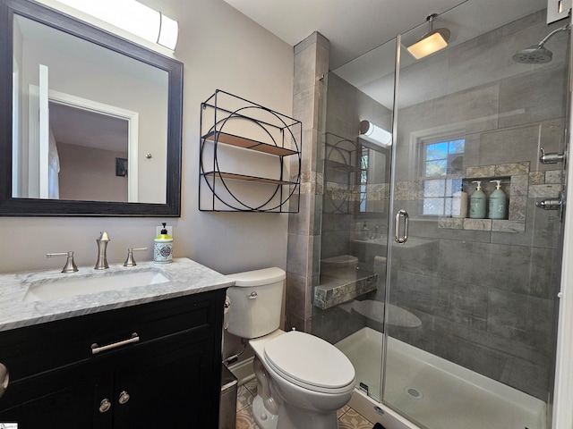 bathroom featuring walk in shower, vanity, and toilet