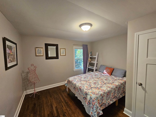 bedroom with dark hardwood / wood-style flooring