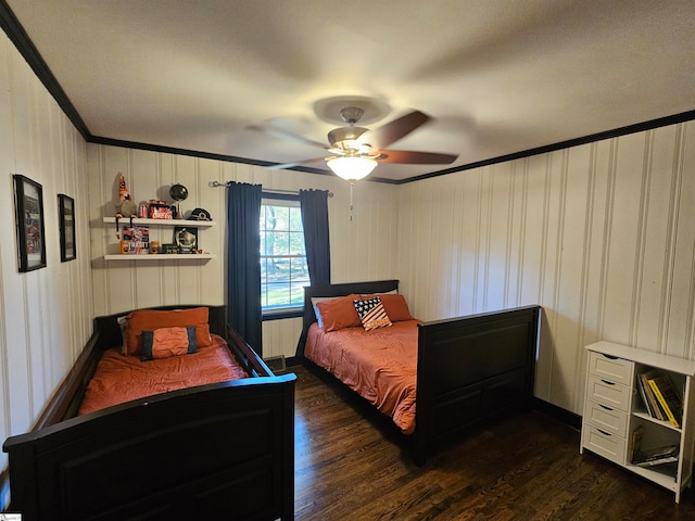 bedroom featuring dark hardwood / wood-style flooring, ornamental molding, and ceiling fan