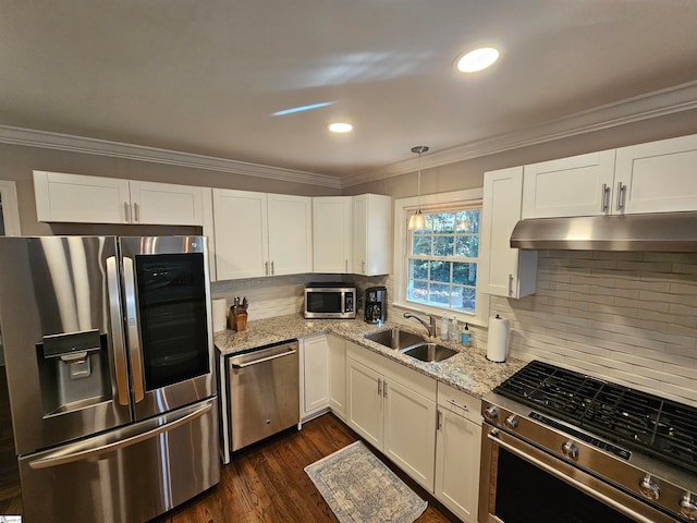 kitchen featuring stainless steel appliances, dark wood-type flooring, pendant lighting, sink, and white cabinetry