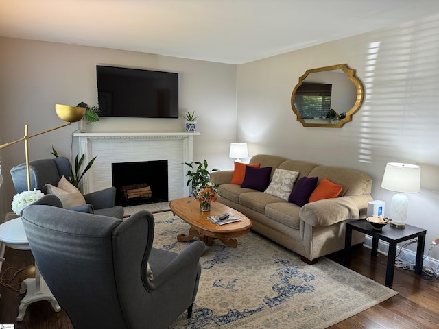 living room with a fireplace and dark hardwood / wood-style flooring