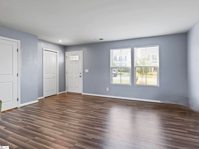 unfurnished room with dark wood-type flooring