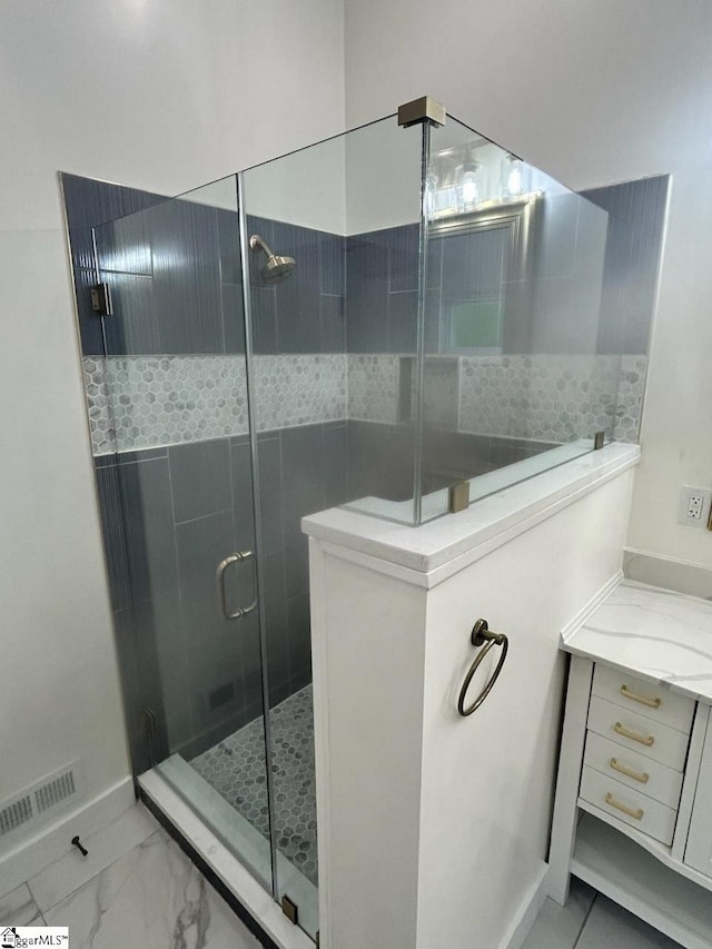 bathroom featuring walk in shower and vanity