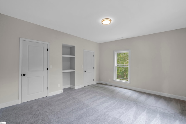 unfurnished bedroom with light colored carpet