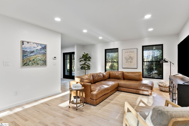 living room with french doors and light hardwood / wood-style floors