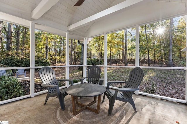 sunroom / solarium featuring lofted ceiling with beams and ceiling fan