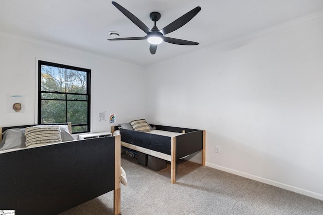 bedroom featuring ceiling fan, ornamental molding, and carpet