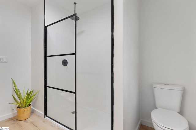 bathroom with walk in shower, wood-type flooring, and toilet