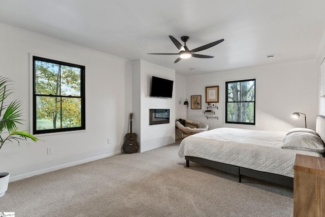 bedroom featuring ceiling fan, carpet flooring, and crown molding