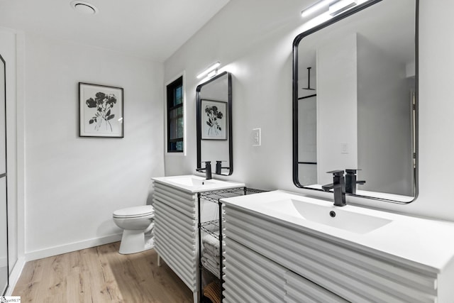 bathroom featuring vanity, hardwood / wood-style flooring, and toilet