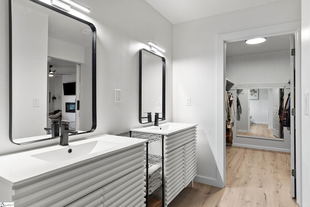 bathroom featuring vanity, hardwood / wood-style floors, and ceiling fan