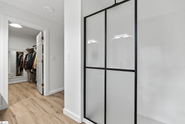 bathroom featuring walk in shower and hardwood / wood-style floors