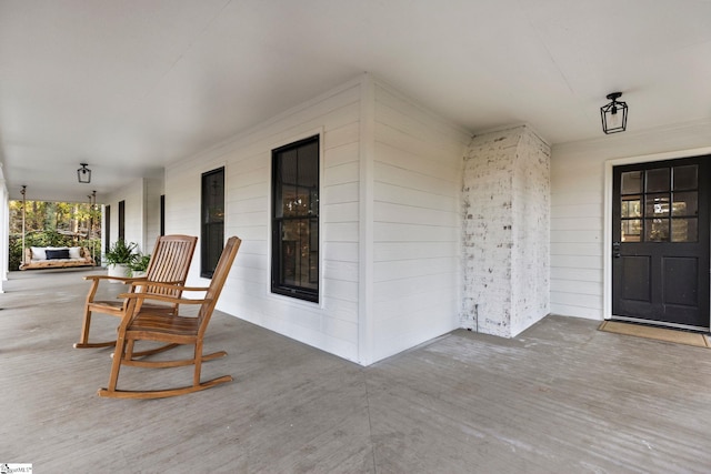 view of exterior entry with covered porch