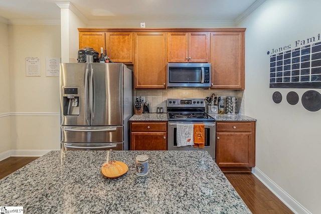 kitchen featuring tasteful backsplash, light stone countertops, stainless steel appliances, and dark hardwood / wood-style floors