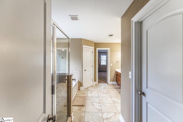 bathroom with vanity and shower with separate bathtub