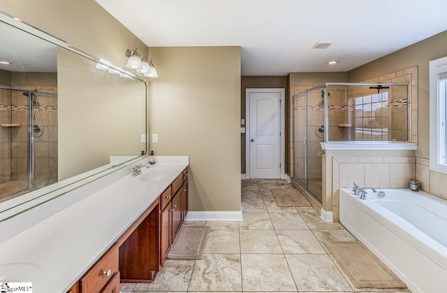 bathroom featuring vanity and separate shower and tub