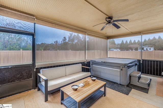 sunroom with wooden ceiling and ceiling fan