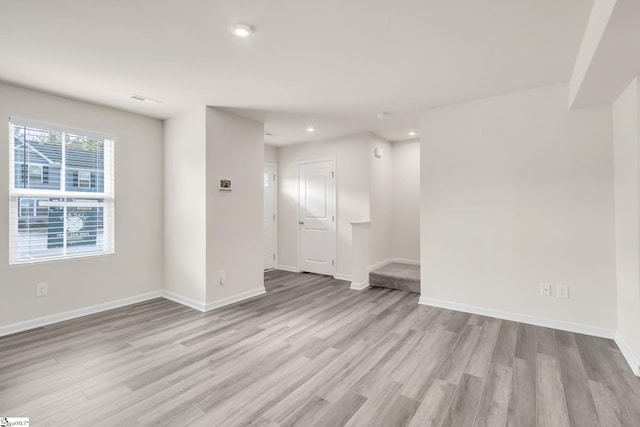 unfurnished room with light hardwood / wood-style floors