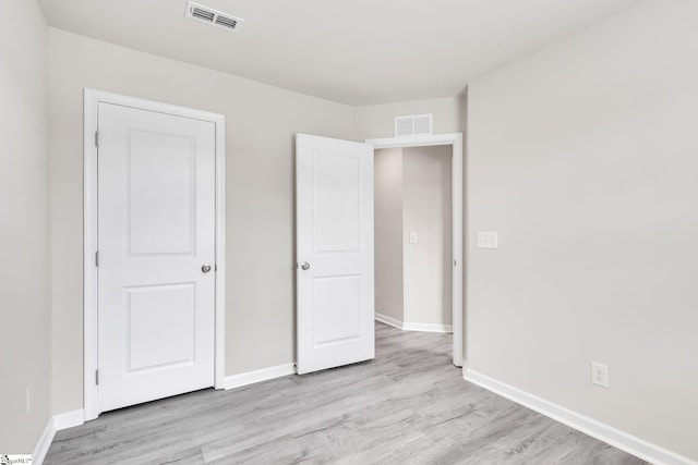 unfurnished bedroom with light wood-type flooring