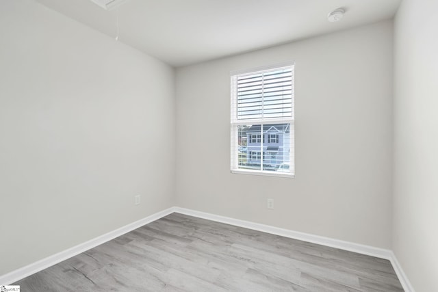 unfurnished room with light wood-type flooring