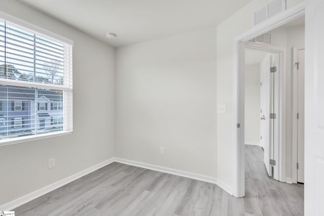 unfurnished room with light wood-type flooring