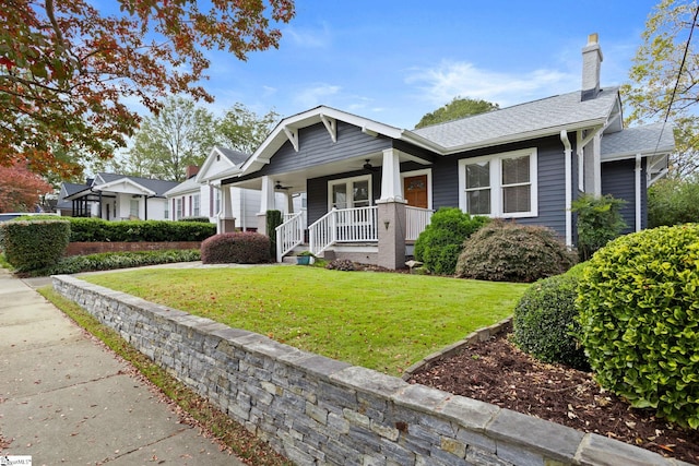 view of front facade with a front lawn and covered porch