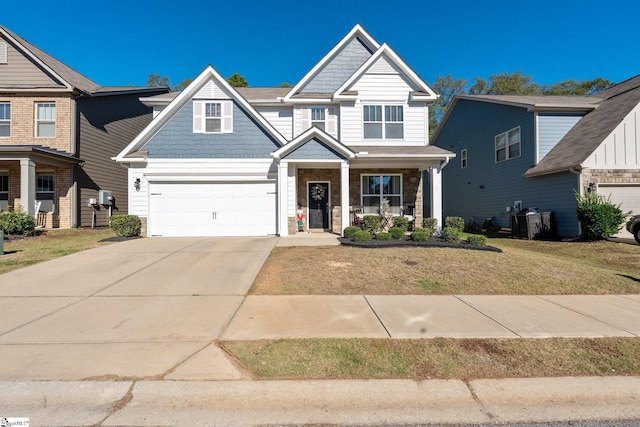 craftsman-style home with a garage, a front yard, and a porch