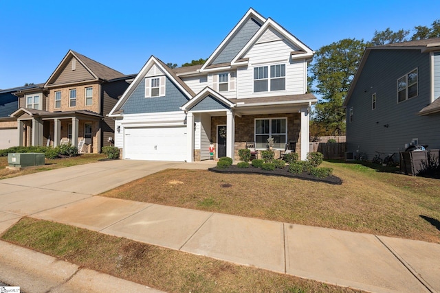 craftsman house with a garage, cooling unit, a front yard, and a porch