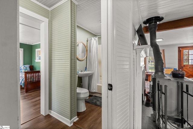 full bathroom featuring toilet, sink, hardwood / wood-style flooring, and ornamental molding