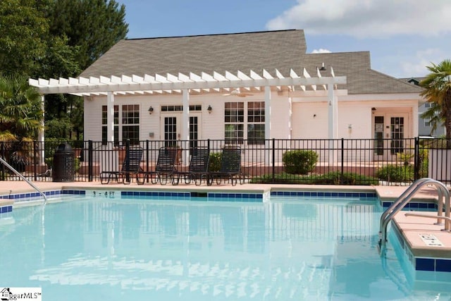 view of pool featuring a pergola and french doors