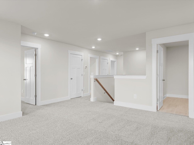 basement featuring light colored carpet