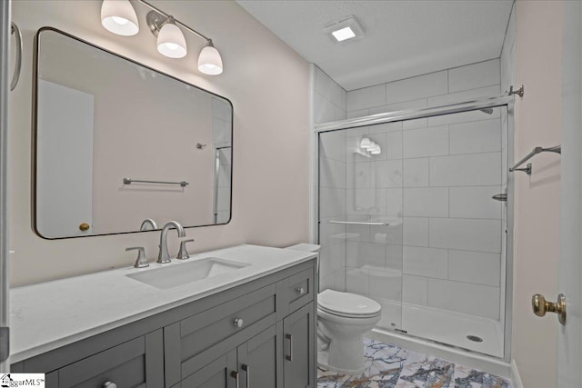 bathroom featuring toilet, an enclosed shower, a textured ceiling, and vanity