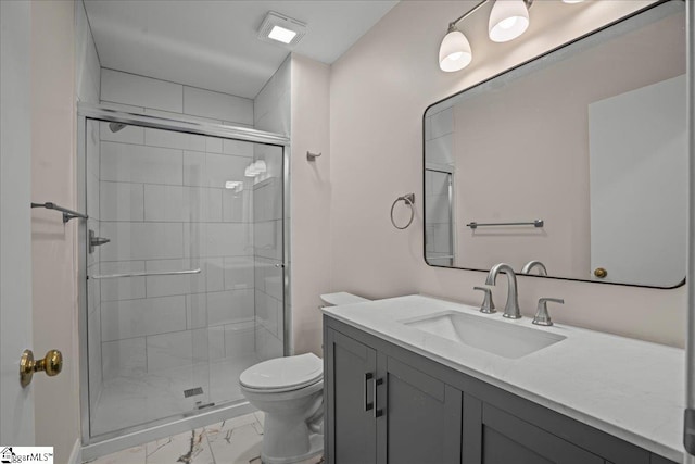 bathroom featuring walk in shower, vanity, and toilet