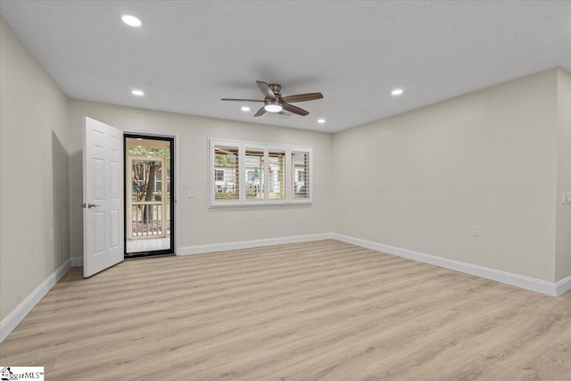 unfurnished room with ceiling fan and light hardwood / wood-style floors