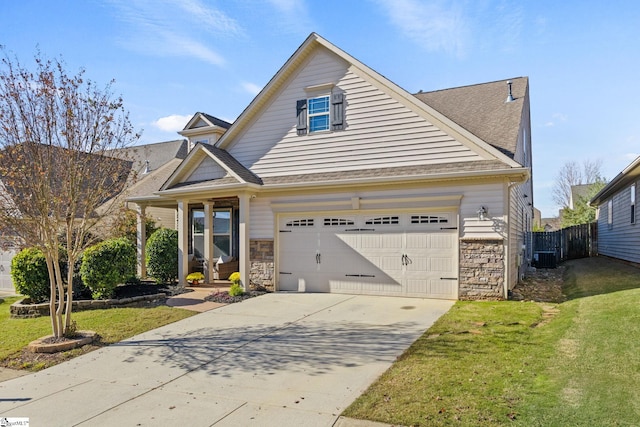 view of front of house featuring a front lawn, central AC unit, and a garage