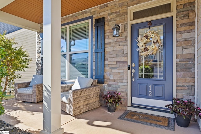 view of exterior entry featuring covered porch