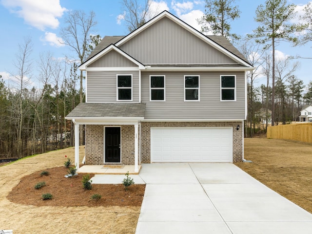 view of front of property featuring a front lawn and a garage