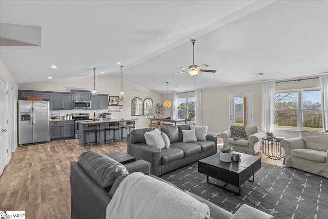 living room with dark hardwood / wood-style floors, ceiling fan, and lofted ceiling