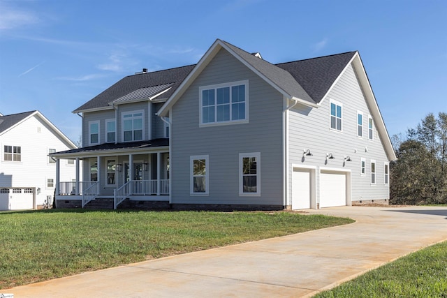 view of front of property with a front yard, a porch, and a garage