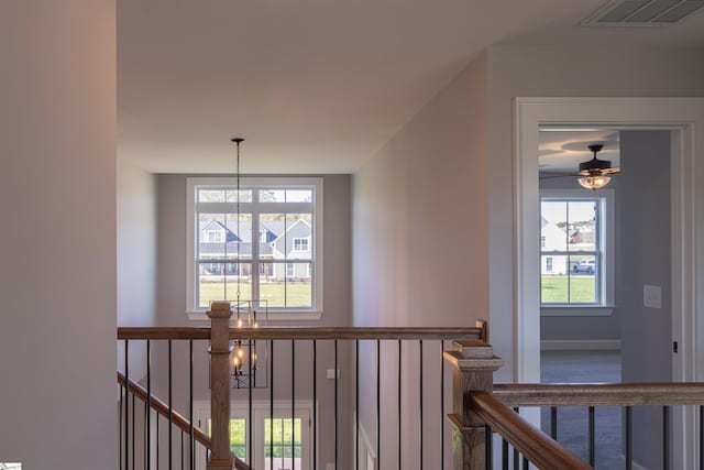 hall featuring an inviting chandelier