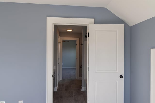 hallway featuring vaulted ceiling