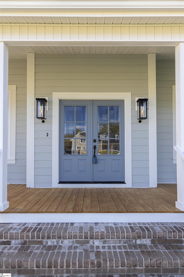 doorway to property with covered porch and french doors