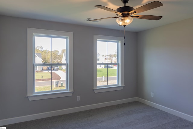 empty room featuring carpet, plenty of natural light, and ceiling fan