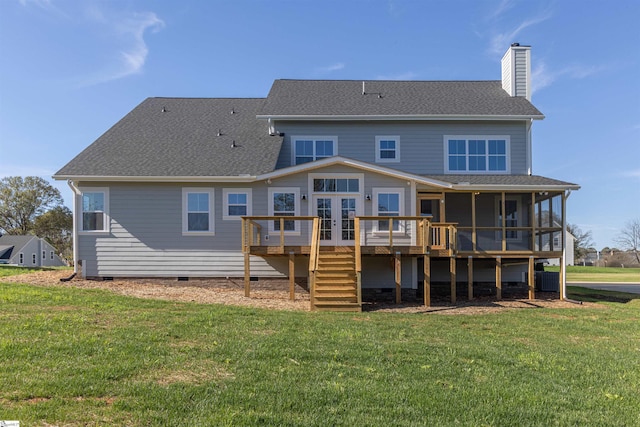 rear view of property with a lawn, a wooden deck, a sunroom, and french doors