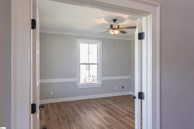 unfurnished room with wood-type flooring, ceiling fan, and crown molding